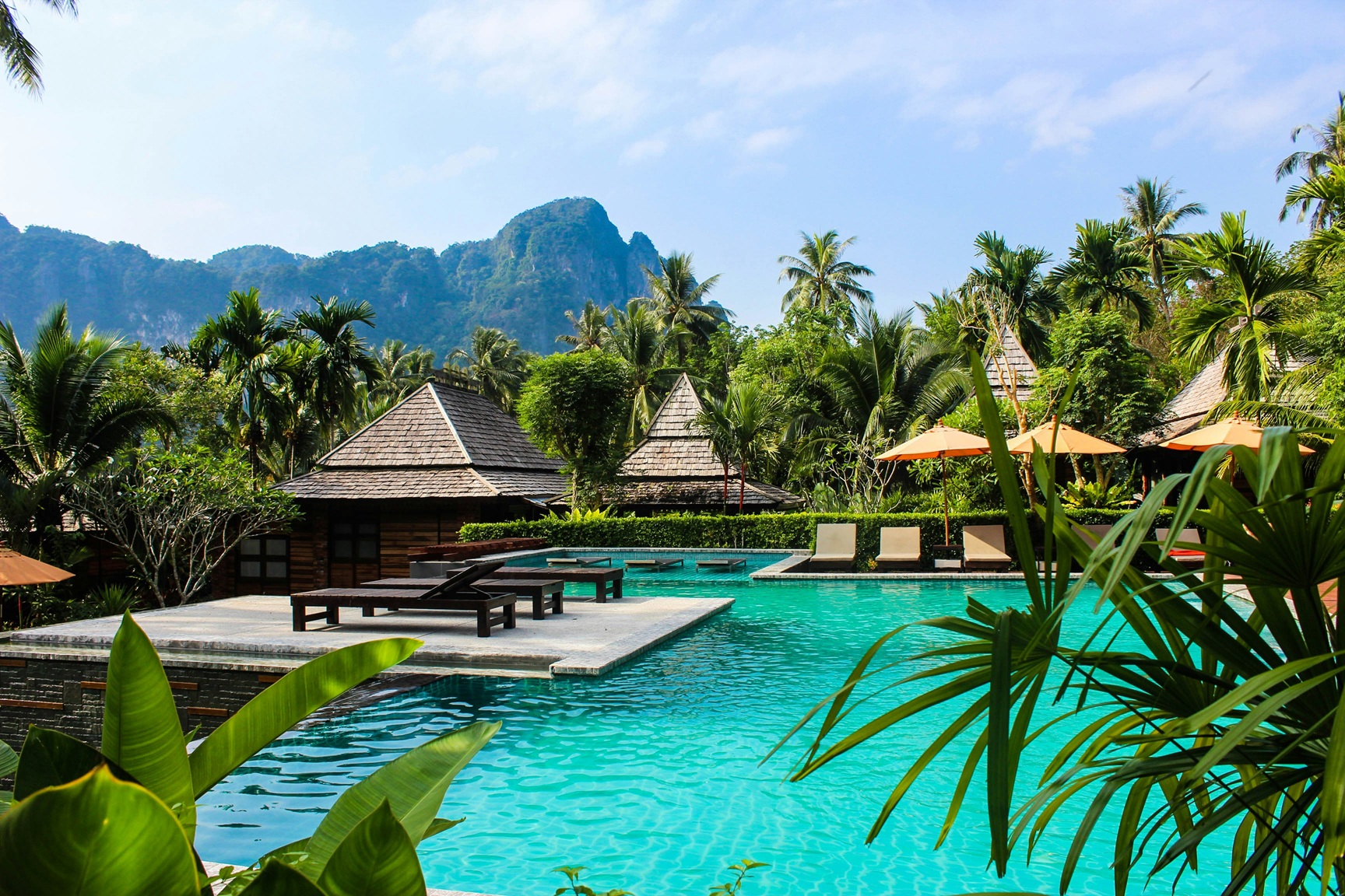 Luxury hotel pool surrounded by lush greenery in Asia — serene concierge travel experience