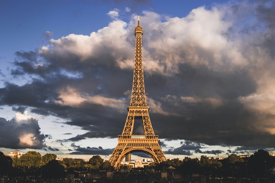 Paris — famous Eiffel at night, glowing under elegant city lights and timeless Parisian atmosphere